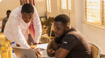 Two male looking on a computer